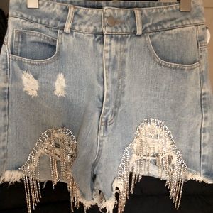 Denim shorts with rhinestone fringe.
